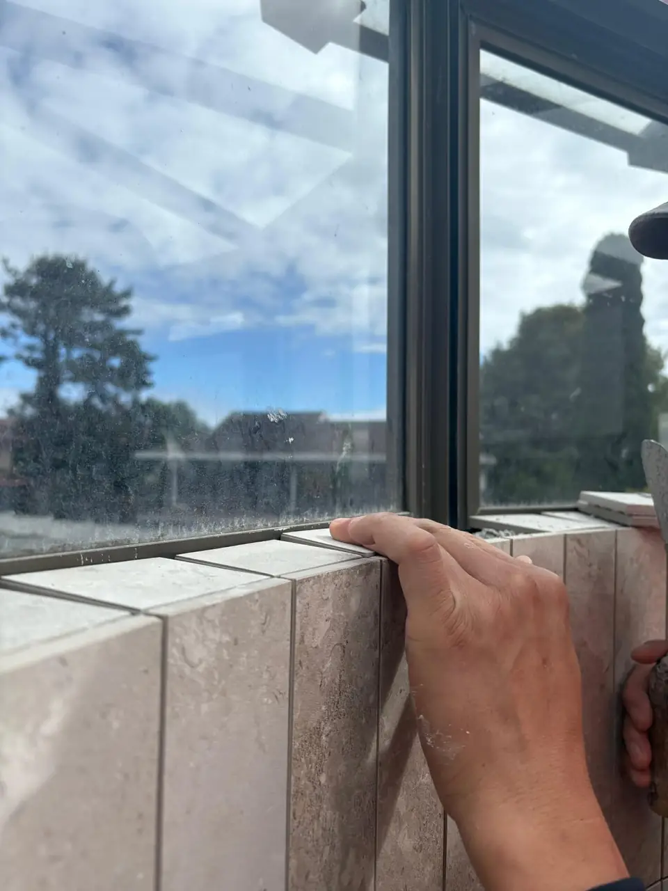 Tiling the window reveal during a bathroom renovation