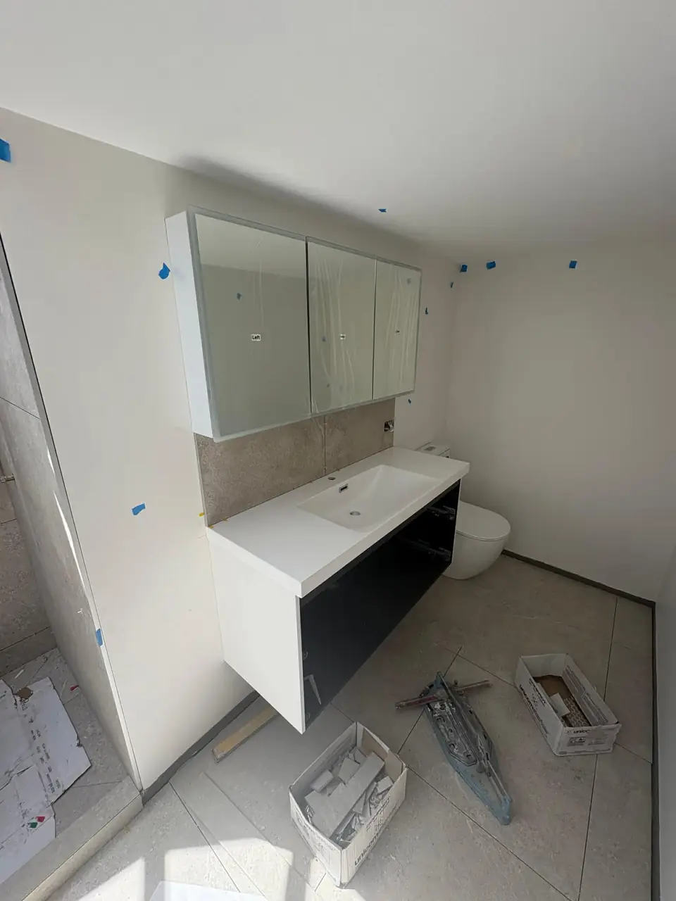 Vanity and mirrored cabinet going in during a bathroom renovation