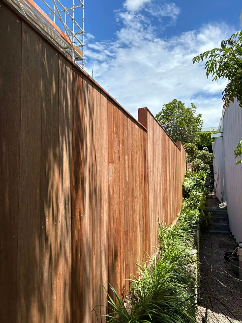 Hardwood fence with planting along its base
