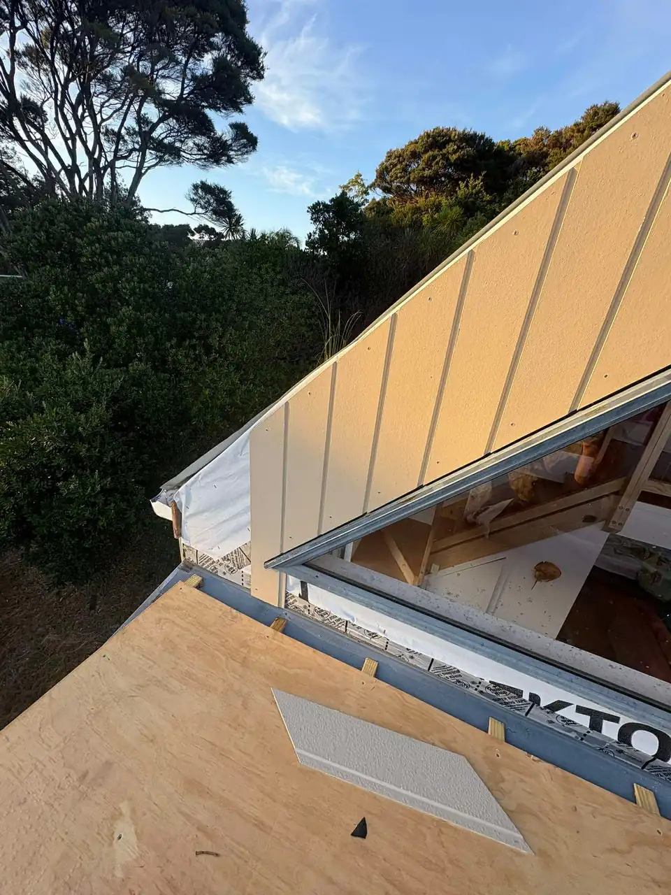 New metal cladding on a steep A-frame roof