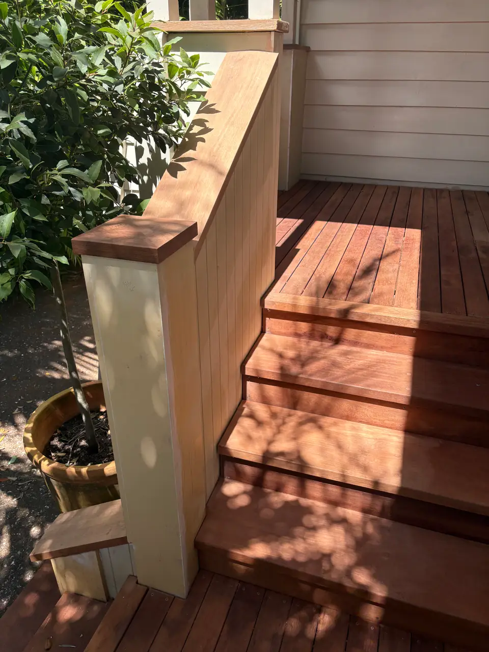 New hardwood porch steps with a painted timber newel post