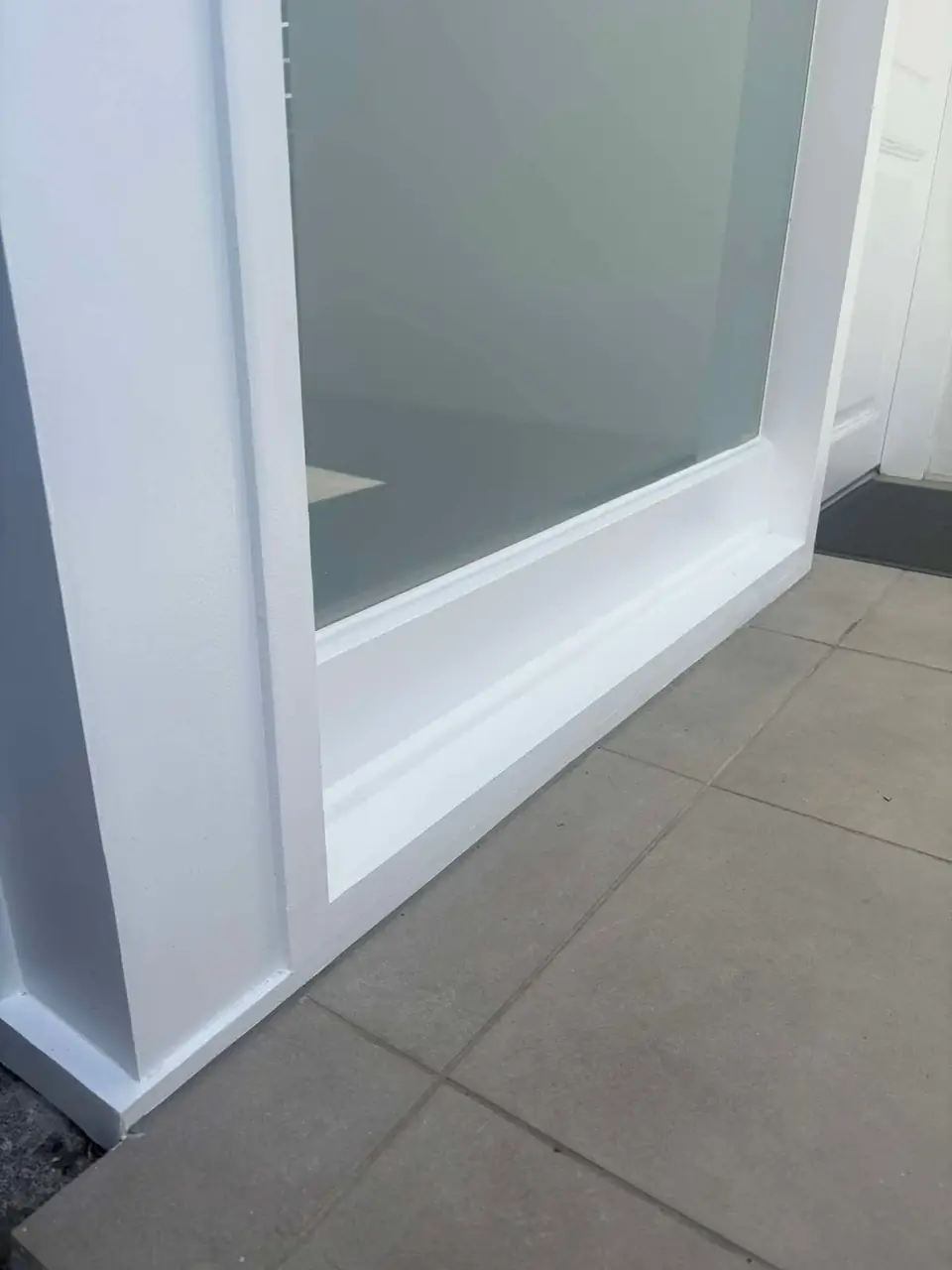 Door frame corner after the rot repair, sealed and painted