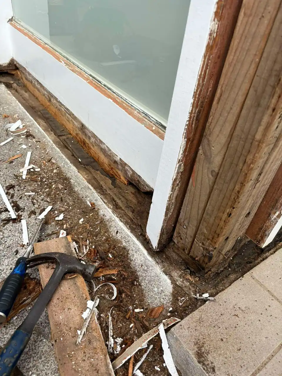 Rotten door jamb and sill exposed during removal