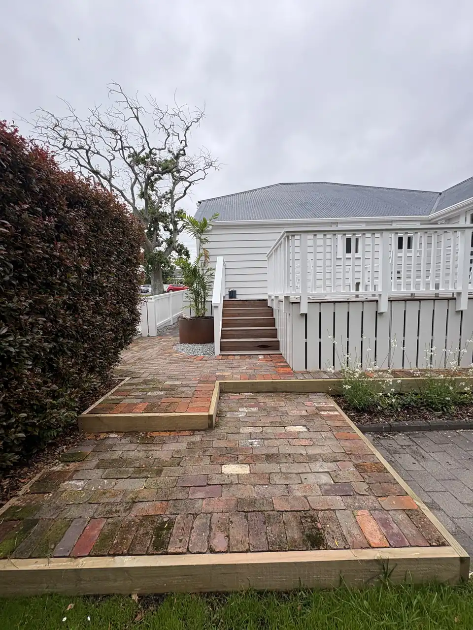 Recycled brick courtyard and garden edging leading to villa steps