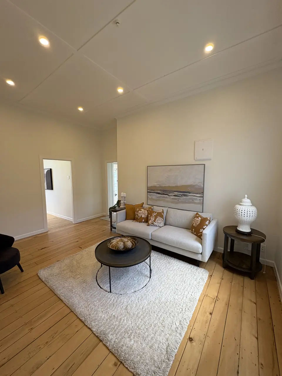 Renovated villa living room with timber floors and downlights
